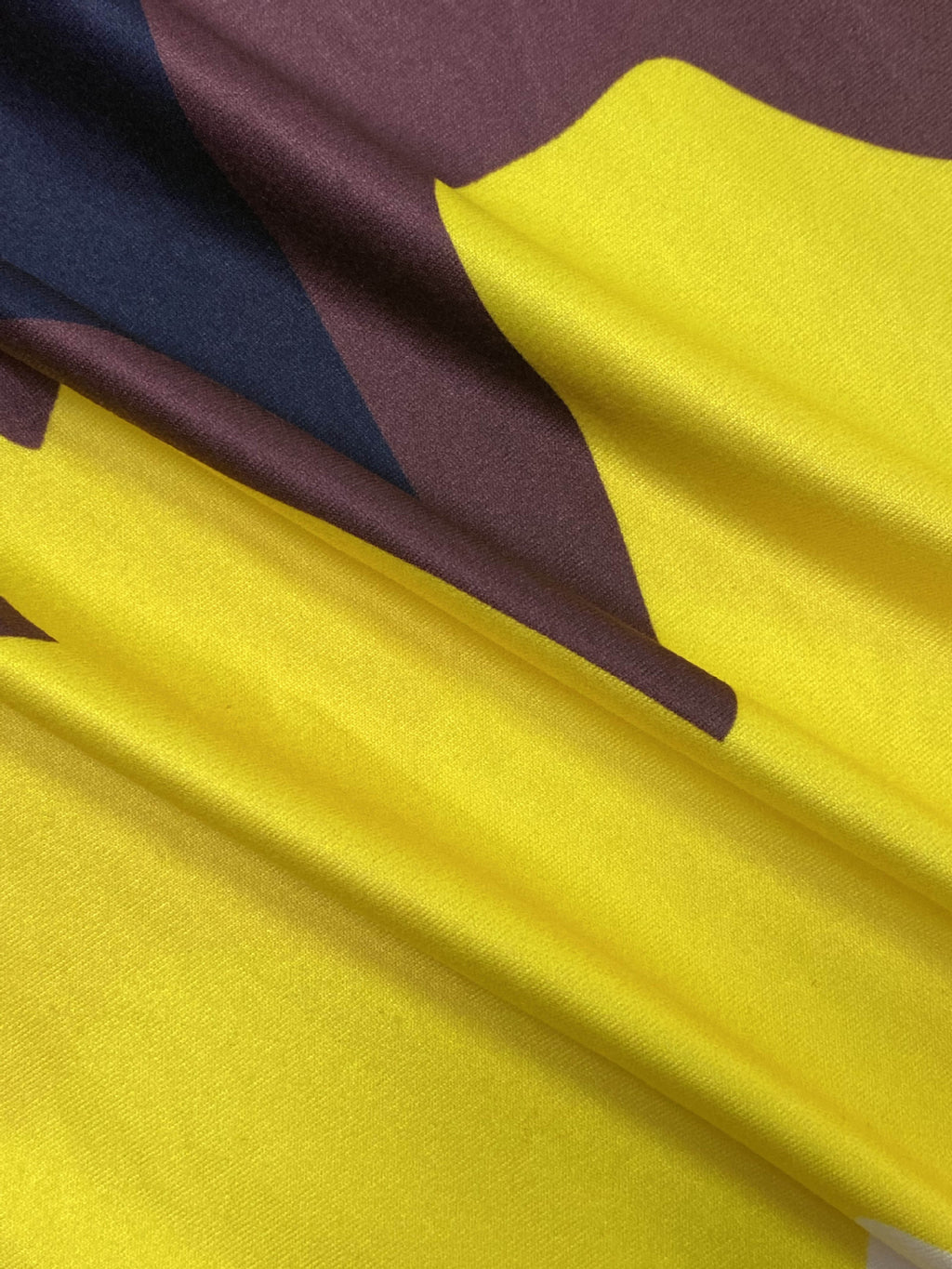Close-up of yellow and dark printed fabric on the color-block polo collar dress.